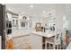Well-equipped kitchen includes white cabinets, a center island with seating, and modern appliances at 5208 Holly Forest, Hollywood, SC 29449