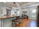Charming kitchen island with bar stool seating, decorative lighting, and hardwood floors at 5208 Holly Forest, Hollywood, SC 29449
