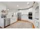 Spacious kitchen boasts white cabinetry, stainless steel appliances, and a patterned rug for added charm at 5208 Holly Forest, Hollywood, SC 29449