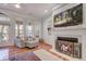 Cozy living room with hardwood floors, fireplace, and large windows providing natural light at 5208 Holly Forest, Hollywood, SC 29449
