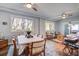 Bright living and dining area with hardwood floors, ceiling fans, and large windows providing ample natural light at 5208 Holly Forest, Hollywood, SC 29449