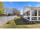 Side yard featuring white fence and an inviting outdoor space with a sunroom view at 5286 Waterview Dr, North Charleston, SC 29418