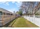 Landscaped backyard with a white fence, offering privacy and a well-manicured lawn at 5286 Waterview Dr, North Charleston, SC 29418
