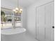 Bright bathroom with standalone tub, modern chandelier and exterior access at 5286 Waterview Dr, North Charleston, SC 29418
