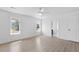 Bright bedroom features neutral walls, wood-look floors, two windows, and a ceiling fan at 5286 Waterview Dr, North Charleston, SC 29418