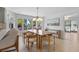 Bright dining area with large windows, wood table, and stylish light fixture at 5286 Waterview Dr, North Charleston, SC 29418