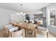 Dining room with modern chandelier, neutral colors, wood floors and seating for six at 5286 Waterview Dr, North Charleston, SC 29418