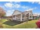Exterior view showcasing the sunroom and lush backyard, ideal for relaxation at 5286 Waterview Dr, North Charleston, SC 29418