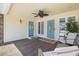 Relaxing front porch with seating, ceiling fan, and vibrant blue doors at 5286 Waterview Dr, North Charleston, SC 29418