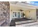Inviting front porch with a brick accent wall, dark wood flooring, and comfortable seating at 5286 Waterview Dr, North Charleston, SC 29418