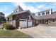 Attached two-car garage with an American flag, complemented by a landscaped yard at 5286 Waterview Dr, North Charleston, SC 29418