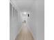 Long hallway with white walls, wood floors, and bi-fold doors at 5286 Waterview Dr, North Charleston, SC 29418