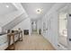 Inviting hallway with staircase, light wood floors, and a modern chandelier at 5286 Waterview Dr, North Charleston, SC 29418