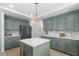 Kitchen featuring an island, stainless steel appliances, light countertops and green cabinets at 5286 Waterview Dr, North Charleston, SC 29418