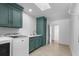 Bright laundry room with modern appliances, green cabinetry and a skylight at 5286 Waterview Dr, North Charleston, SC 29418