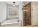 Bathroom featuring a whirlpool tub and glass-enclosed shower at 5556 Indigo Fields Blvd, North Charleston, SC 29418