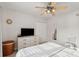 Serene bedroom with a ceiling fan, dresser with television, neutral decor and lots of natural light at 5556 Indigo Fields Blvd, North Charleston, SC 29418