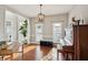 Warm dining room with a charming chandelier and hardwood floors, complemented by natural light at 5556 Indigo Fields Blvd, North Charleston, SC 29418