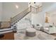 Open-concept living room with staircase and hardwood floors at 5556 Indigo Fields Blvd, North Charleston, SC 29418