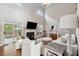 Inviting living room featuring a cozy fireplace, high ceilings, and sliding doors to the outdoor deck and pool at 5556 Indigo Fields Blvd, North Charleston, SC 29418