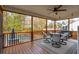Relaxing screened porch featuring a dining area, swing, ceiling fan and a view of the backyard at 5556 Indigo Fields Blvd, North Charleston, SC 29418