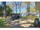 Backyard with a grill, lush greenery, wooden deck, shed, and perimeter fencing at 5801 Chaucer Dr, Hanahan, SC 29410