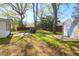 A view of the backyard with a shed and grill on a well-maintained lawn with mature trees at 5801 Chaucer Dr, Hanahan, SC 29410