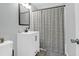 Well-lit bathroom featuring a white vanity and a shower with a striped curtain, offering a clean and modern look at 5801 Chaucer Dr, Hanahan, SC 29410