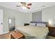 Comfortable bedroom featuring hardwood floors, ceiling fan, and a plush bed creates a relaxing atmosphere at 5801 Chaucer Dr, Hanahan, SC 29410