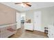 bedroom featuring a crib, dresser, and hardwood floors creating a cozy and functional space at 5801 Chaucer Dr, Hanahan, SC 29410