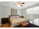 Cozy bedroom with wood floors, a ceiling fan, and a comfortable bed creating a peaceful retreat at 5801 Chaucer Dr, Hanahan, SC 29410