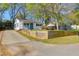 Charming home showcasing a bright front door, a neat lawn, and a paved driveway at 5801 Chaucer Dr, Hanahan, SC 29410