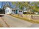 Exterior view with curb appeal; showcasing a front yard, driveway, and blue front door at 5801 Chaucer Dr, Hanahan, SC 29410