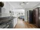 Well-lit kitchen boasting modern appliances, sleek countertops, and stylish wood-look floors at 5801 Chaucer Dr, Hanahan, SC 29410