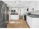 Modern kitchen features white cabinetry, black appliances, and stylish vinyl wood floors at 5801 Chaucer Dr, Hanahan, SC 29410