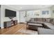 Comfortable living space with gray sectional, light green walls, and elegant wood-look floors at 5801 Chaucer Dr, Hanahan, SC 29410