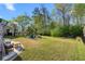 Expansive backyard featuring a fire pit with Adirondack chairs and a hammock, ideal for outdoor enjoyment at 6005 Coral Berry Rd, Hanahan, SC 29410