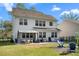 Beautiful backyard with outdoor seating, a fire pit, and a well-maintained lawn at 6005 Coral Berry Rd, Hanahan, SC 29410