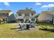 Well-manicured backyard features a charming fire pit area with outdoor seating for relaxation at 6005 Coral Berry Rd, Hanahan, SC 29410