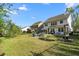 Landscaped backyard with a fire pit, swing, and a fence, perfect for entertaining and relaxation at 6005 Coral Berry Rd, Hanahan, SC 29410