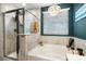 Close-up of bathroom showing tiled shower and tub beneath a chandelier at 6005 Coral Berry Rd, Hanahan, SC 29410