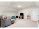 Spacious carpeted bonus room, complete with a gray sofa and a television for entertainment at 6005 Coral Berry Rd, Hanahan, SC 29410