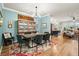 Stylish dining room with modern chandelier, seating for six, colorful rug, and open-concept design at 6005 Coral Berry Rd, Hanahan, SC 29410