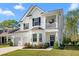 Charming two-story home with a two-car garage, a balcony, and a well-manicured front yard at 6005 Coral Berry Rd, Hanahan, SC 29410