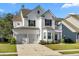 Charming two-story home with a two-car garage, a balcony, and a well-manicured front yard at 6005 Coral Berry Rd, Hanahan, SC 29410
