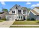 Charming two-story home with a two-car garage, a balcony, and a well-manicured front yard at 6005 Coral Berry Rd, Hanahan, SC 29410