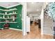 Inviting foyer with hardwood floors, staircase, decorative shelves, and a glimpse into other living spaces at 6005 Coral Berry Rd, Hanahan, SC 29410