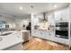 Bright kitchen with stainless steel appliances, white cabinets, tile backsplash, and ample counter space at 6005 Coral Berry Rd, Hanahan, SC 29410