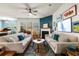 Bright living room with hardwood floors, two sofas, fireplace, and a colorful rug at 6005 Coral Berry Rd, Hanahan, SC 29410