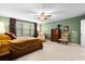 Bright and airy primary bedroom featuring a king bed, seating area, and ample closet space at 6005 Coral Berry Rd, Hanahan, SC 29410